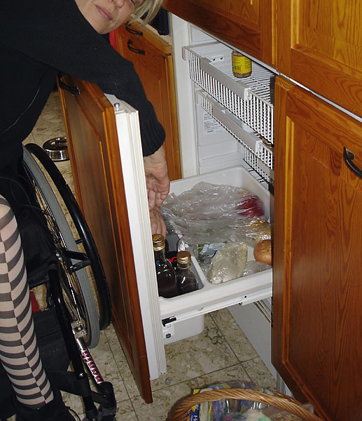 User leans on open refrigerator door