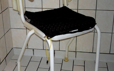 Shower chair with soft back and swinging armrest