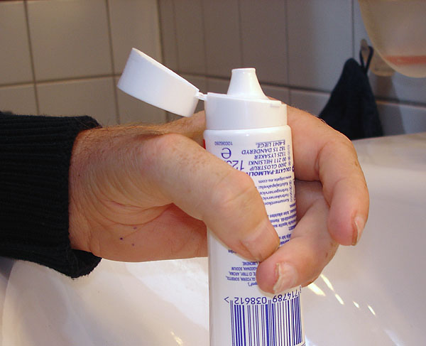 Plastic toothpaste tube with flip-top lid, open