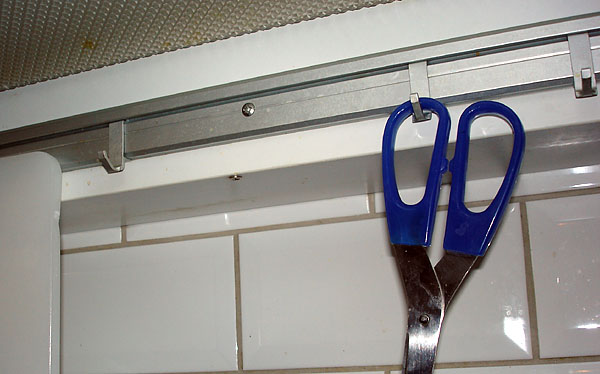 Bracket with s-hooks (scissors hanging on one of the hooks)