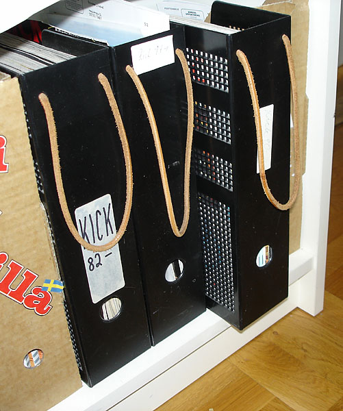 Magazine holder with leather shoelace forming a loop as handle.