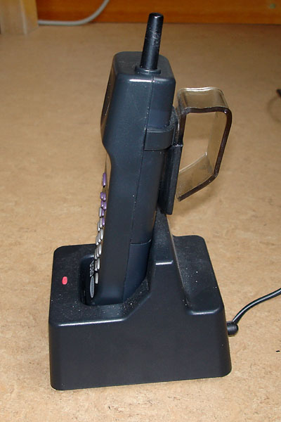Portable telephone with Plexiglas handle