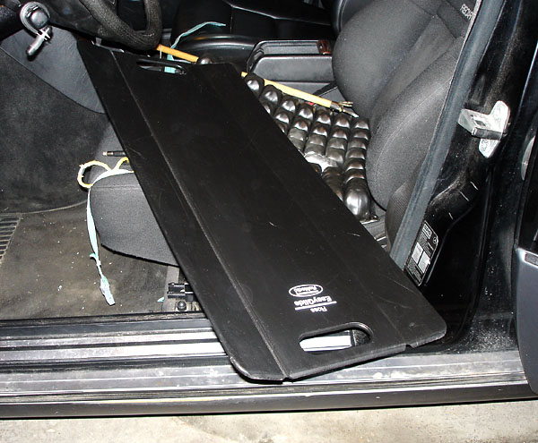Sliding board in black plastic on car seat