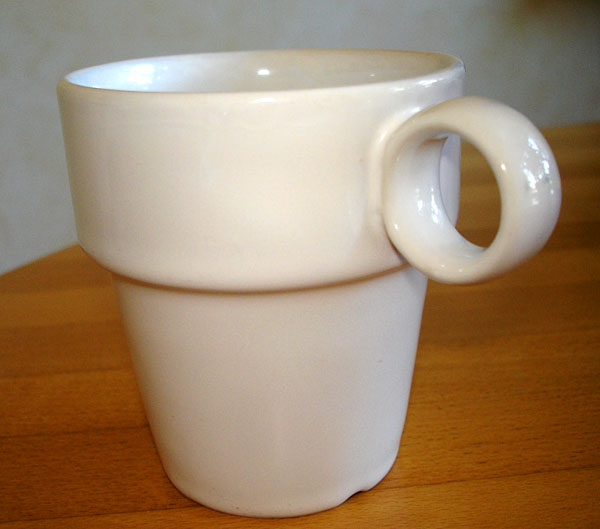 China mug with handle designed as a round loop, just the right size for the user's thumb.