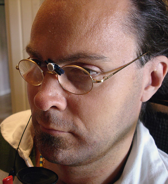 User with glasses, a small clothpin with reflector on the glasses.