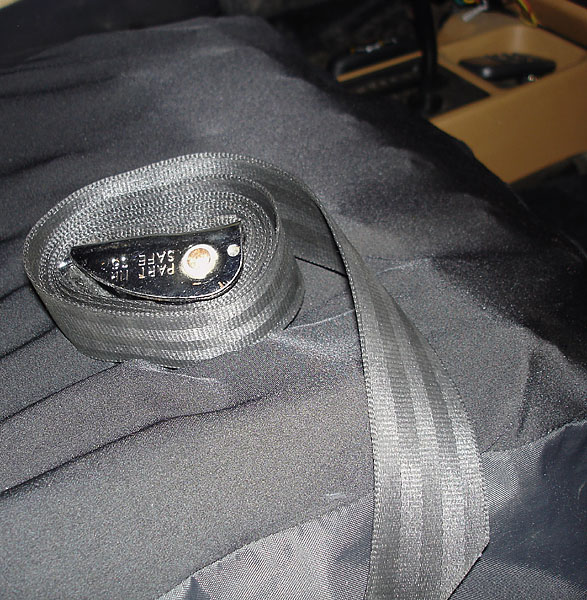 An nylon belt laying on a Roho cushion.