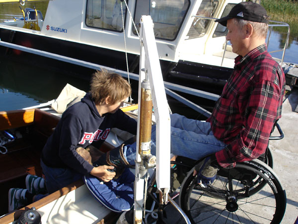 User receives help to place feet on deck