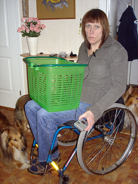 User with plastic basket on lap