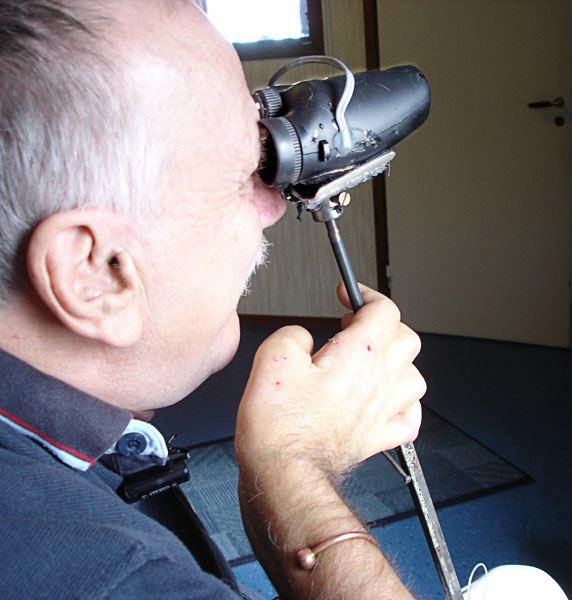 User looks through binoculars