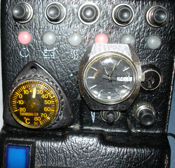 Thermometer and clock on electric wheelchair’s control panel (close-up)
