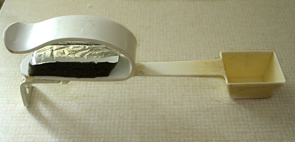 Coffee scoop - the handle is adapted with a craddle in orthosis material