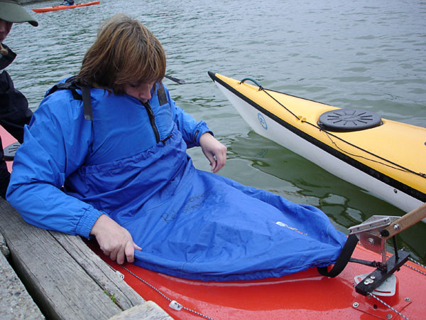 User with kayak skirt in kayak 
