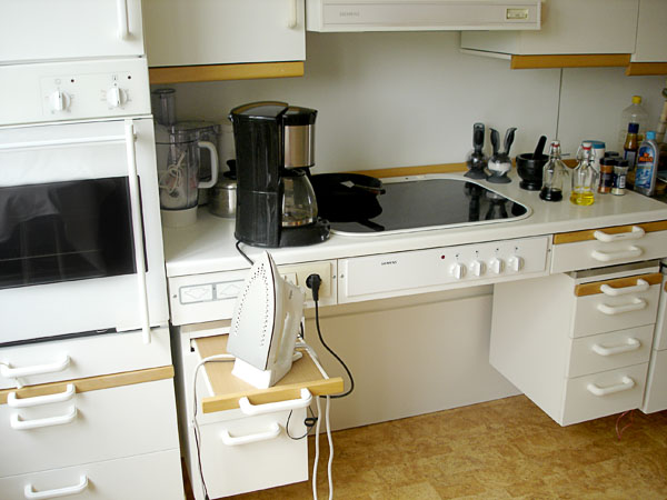 Stove without lower cabinet, pull-out board and oven in accessible kitchen
