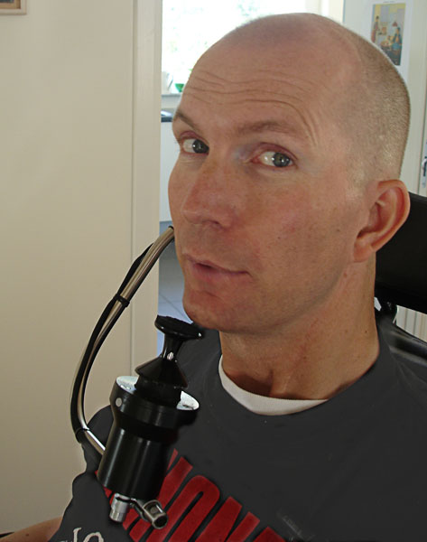 User with the joystick of chin steering under his chin