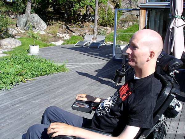 The user sits on a large wooden terrace.