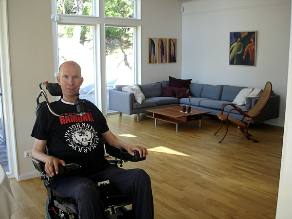 The user in his spacious living room, sitting area in the background.
