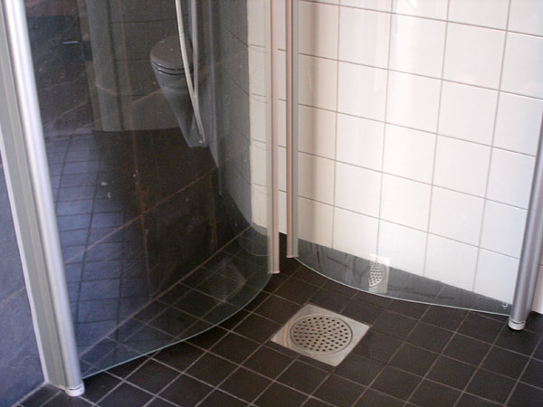 Shower stall with glass doors folded inward