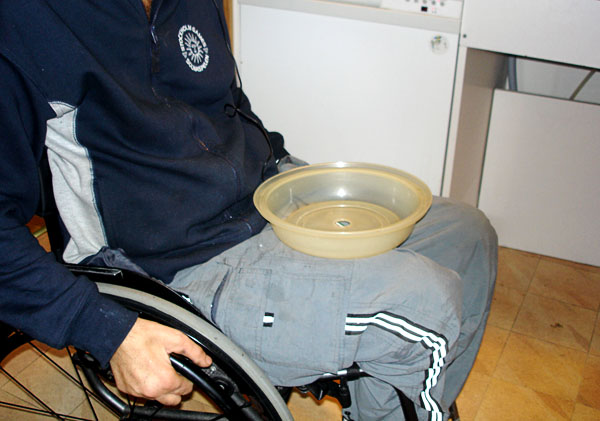 User with plastic tray on lap