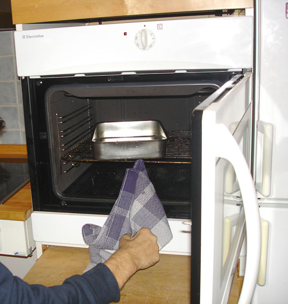 Oven with pull-out board under it