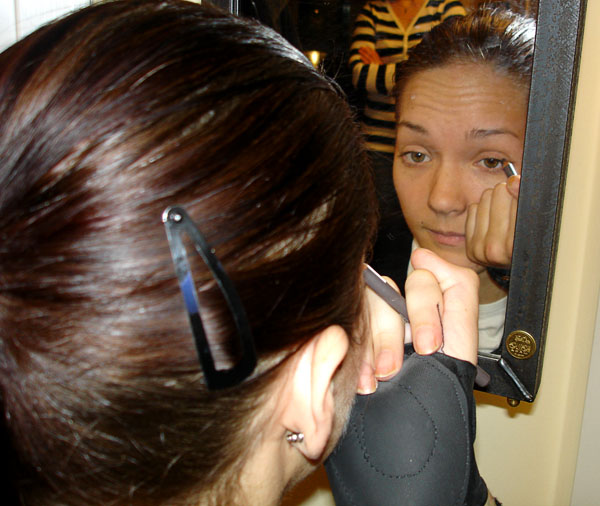 Applying eyeliner