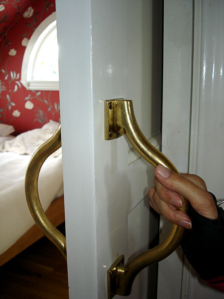 Sliding door with brass handles (close-up)