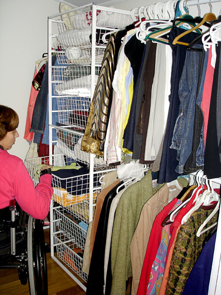 User in clothes closet