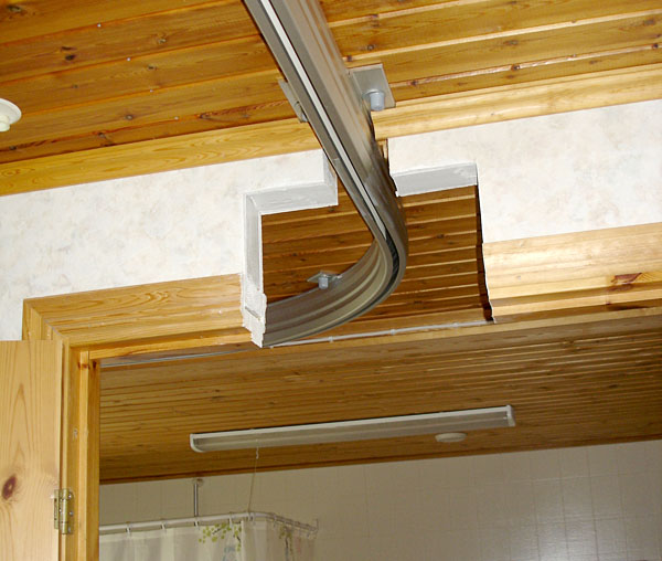 Ceiling track through wall opening above the bathroom door (close.up)