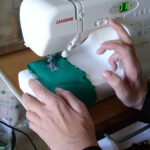 Portable electronic sewing machine