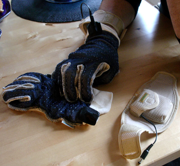 User with heated gloves and battery pack on