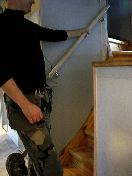 User holds onto stairway railing