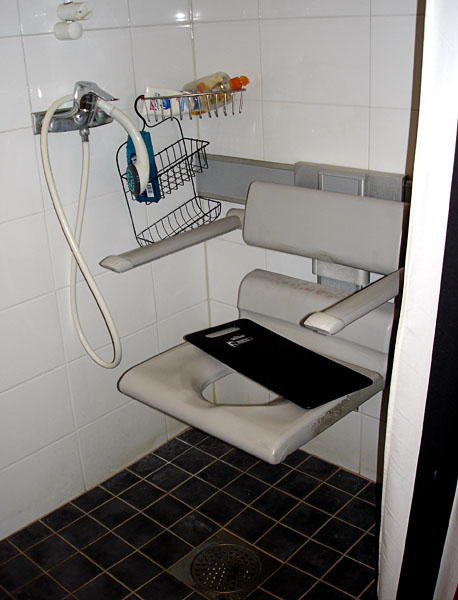 Pressalit shower stool with backrest and armrest