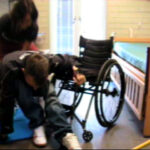Transfer from wheelchair to floor with assistance