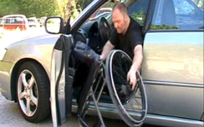 Lifting a wheelchair out of a passenger car