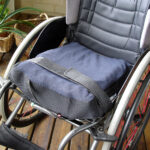 Wheelchair – strap that holds wheelchair cushion in place