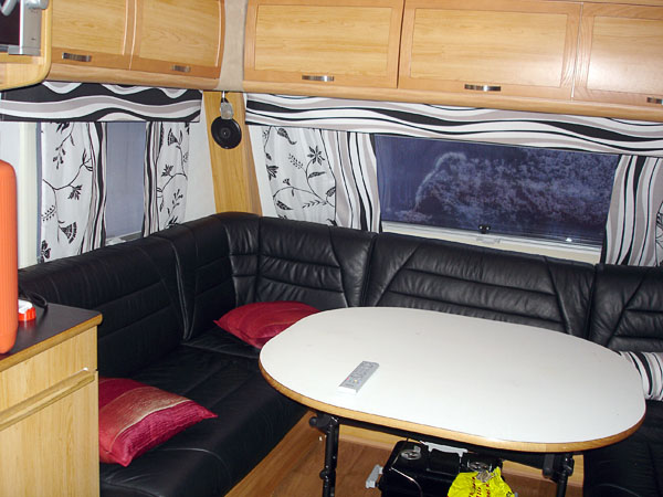 Caravan from inside. Corner sofa and table.