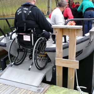 Folding bow ramp in accessible boat