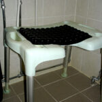 Shower stool with pressure-relieving cushion