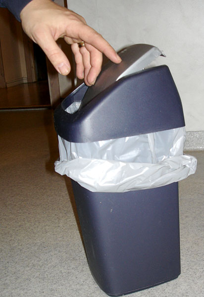 User opens wastebasket lid by pressing on the lid