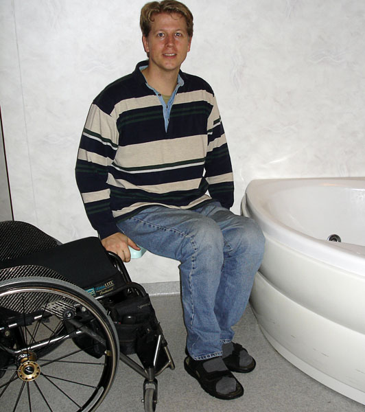 User on stool next to the bathtub