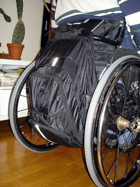 User with backpack on wheelchair