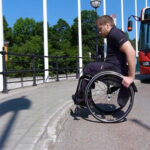 Go up a curb in a wheelchair