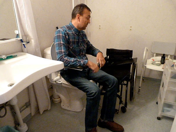User seated on toilet