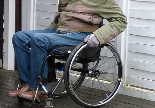 Användaren kör rullstol med arbetshandskar