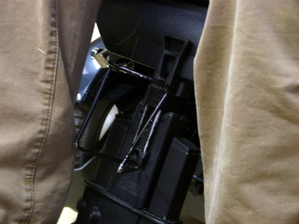 Water bottle holder attached to wheelchair leg support (close-up)