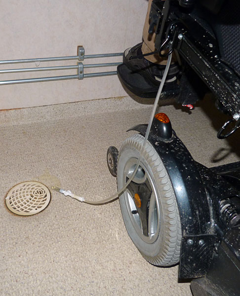 User empties urine bag in floor drain