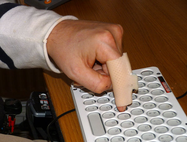 User types on keyboard using finger sleeve