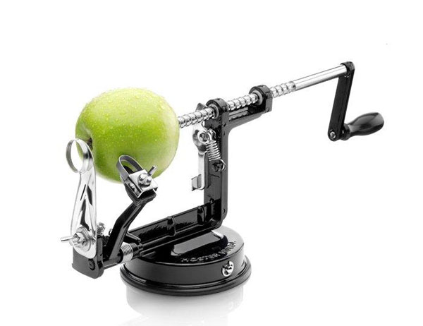 An apple sits on a rotating spit that is rotated with a small handle. A peeler with a spring is pressed against the apple.