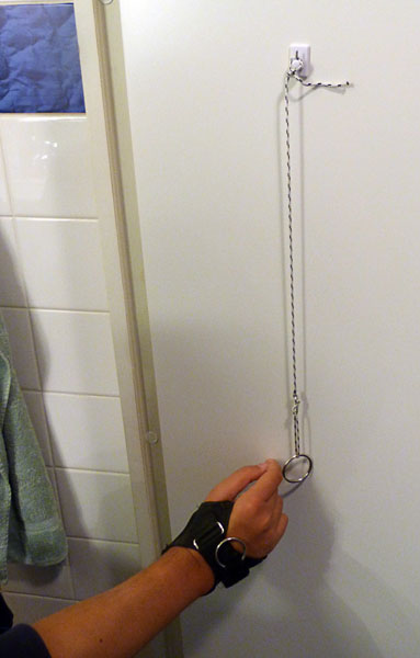 A string ending with a key ring is attached to the bathroom door.