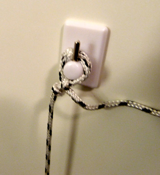 String attached to a hook on the door (close-up)