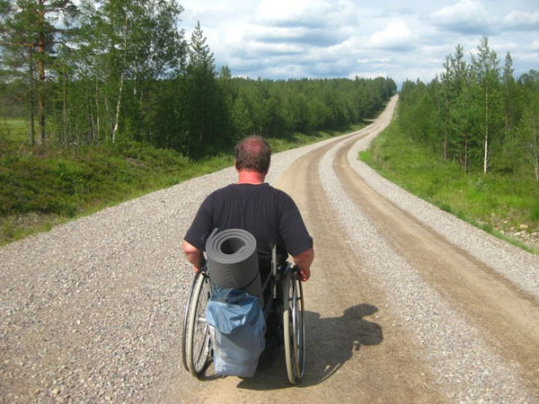 User with pack on wheelchair. Photo: from the user's archives